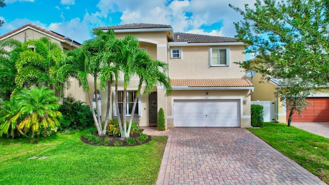 mediterranean / spanish home with a front yard and a garage