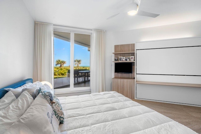 carpeted bedroom featuring ceiling fan and access to exterior