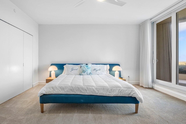 bedroom featuring light carpet, a closet, and ceiling fan