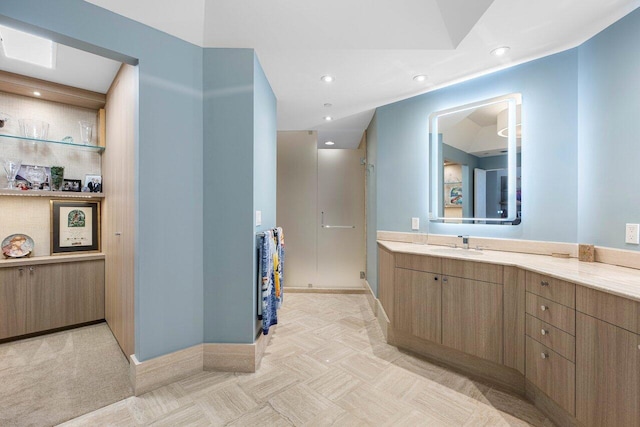 bathroom with vanity and a shower with shower door