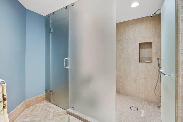 bathroom featuring tile patterned flooring, tile walls, and walk in shower