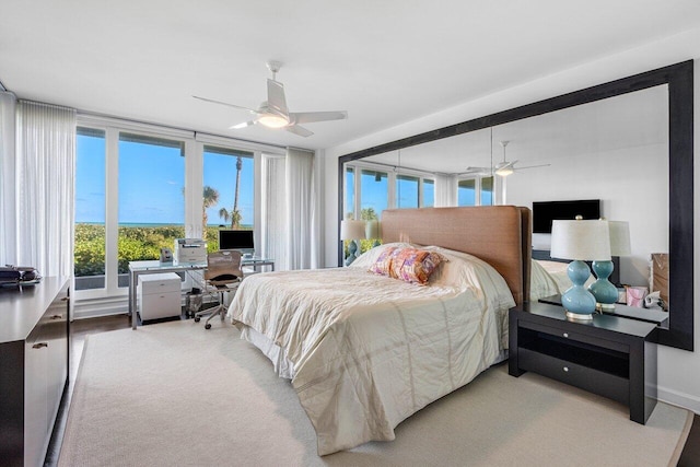 carpeted bedroom with multiple windows and ceiling fan