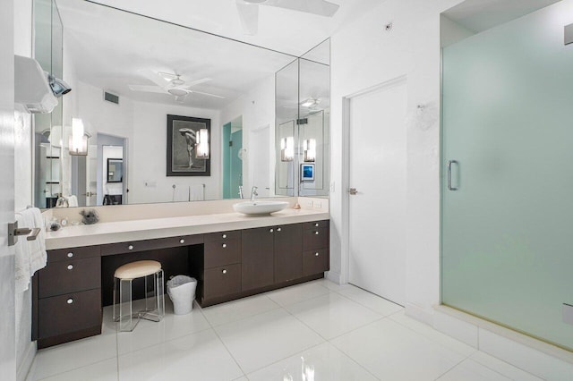 bathroom with tile patterned floors, ceiling fan, a shower with door, and vanity