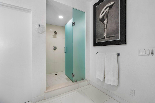 bathroom with tile patterned floors and a shower with door