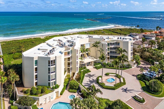 bird's eye view featuring a water view and a beach view