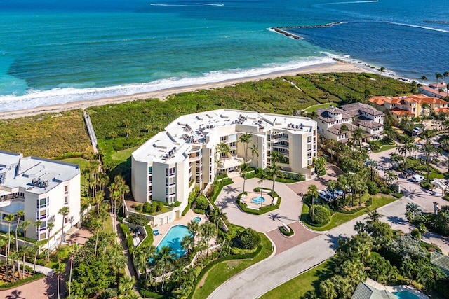 bird's eye view with a water view and a beach view