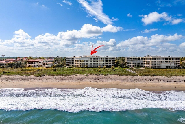 bird's eye view with a water view and a view of the beach