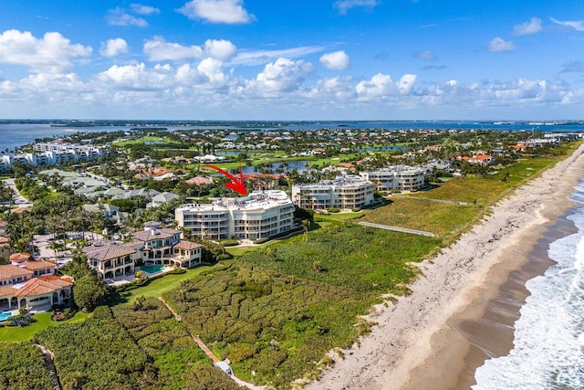 birds eye view of property featuring a view of the beach and a water view