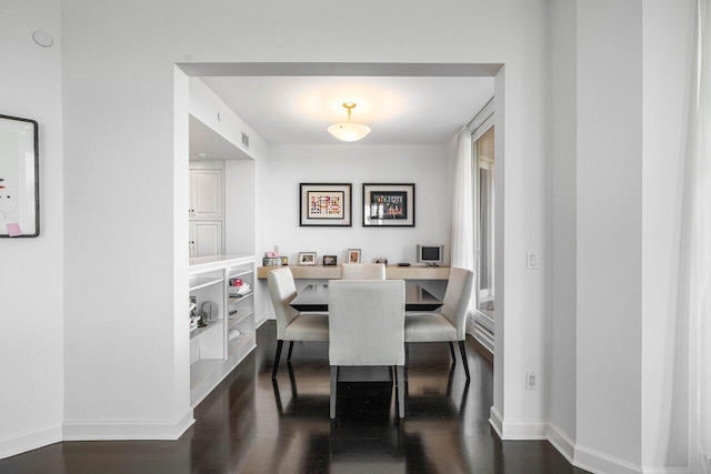 dining room with dark hardwood / wood-style flooring