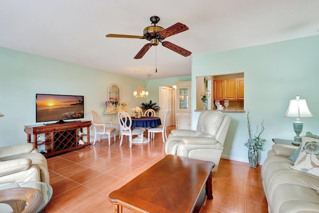 tiled living room featuring ceiling fan with notable chandelier