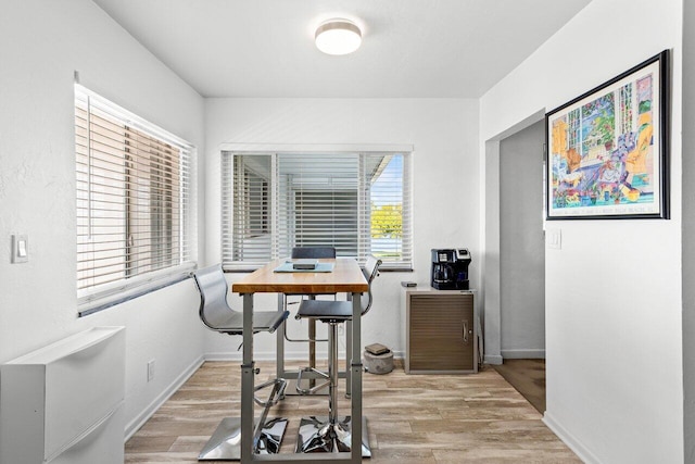 dining space with light hardwood / wood-style flooring