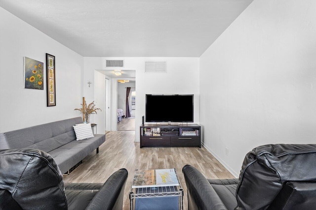 living room with light hardwood / wood-style flooring