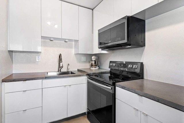 kitchen featuring white cabinetry, sink, and black range with electric cooktop