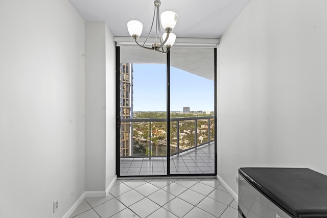 dining space featuring a wealth of natural light, light tile patterned floors, and a chandelier