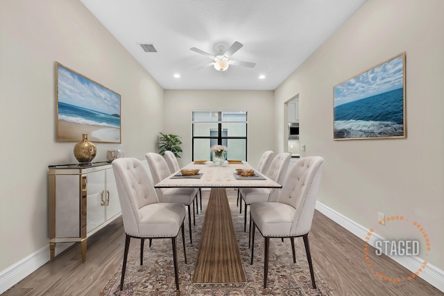 dining area featuring dark hardwood / wood-style floors and ceiling fan