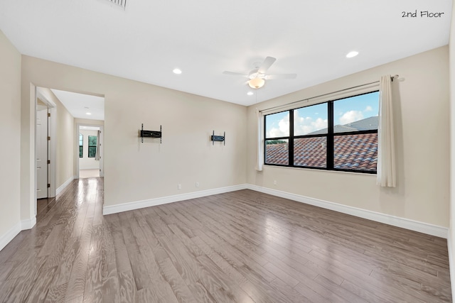 spare room with ceiling fan and light hardwood / wood-style floors