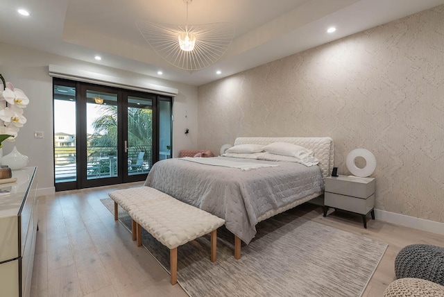 bedroom with access to outside, light hardwood / wood-style floors, and ceiling fan