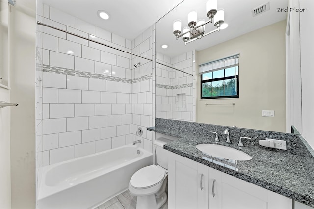 full bathroom with tiled shower / bath combo, toilet, wood-type flooring, and vanity