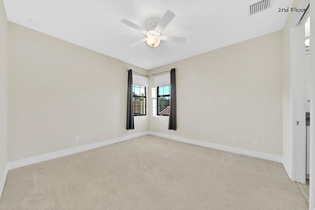 unfurnished room featuring ceiling fan and light colored carpet