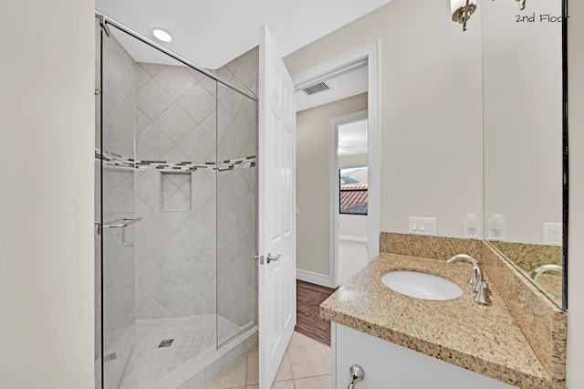 bathroom featuring vanity, tile patterned floors, and an enclosed shower