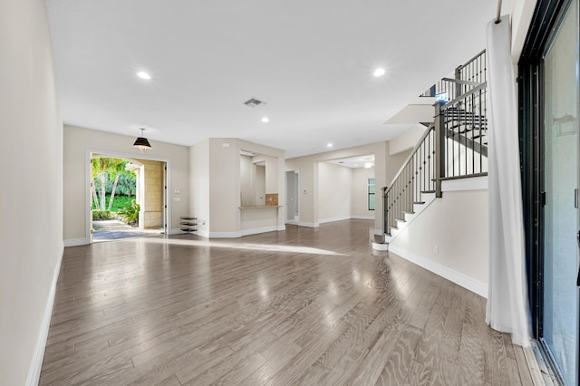 unfurnished living room featuring hardwood / wood-style flooring