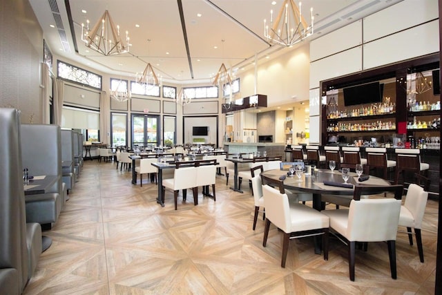 dining area featuring light parquet floors and a high ceiling