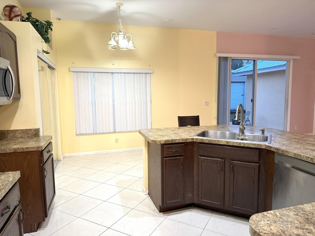 kitchen featuring sink, an inviting chandelier, pendant lighting, light tile patterned floors, and appliances with stainless steel finishes