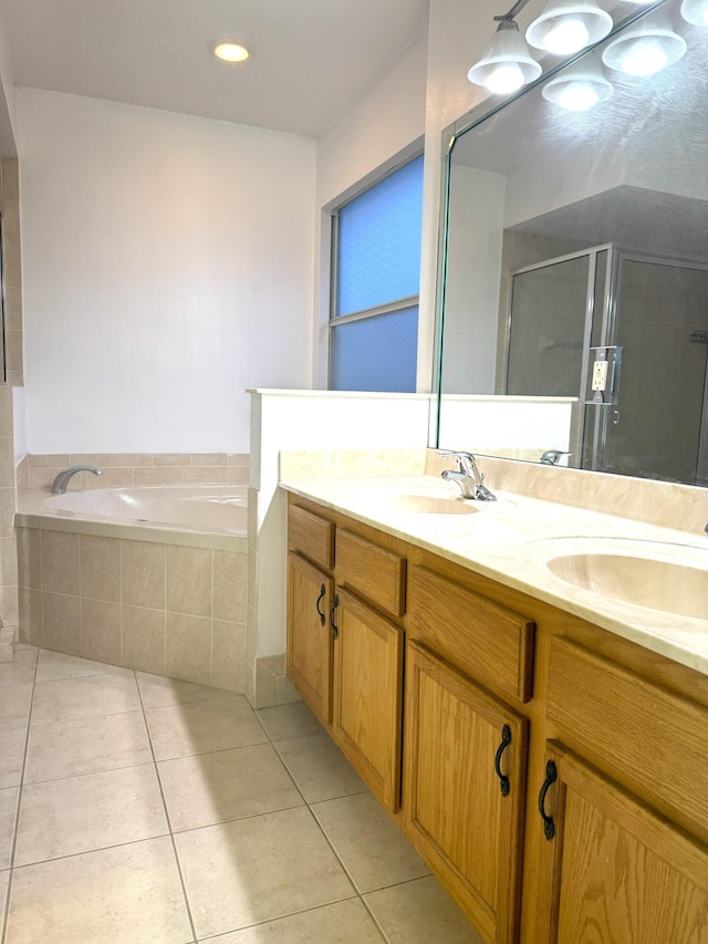 bathroom featuring tile patterned flooring, vanity, and separate shower and tub