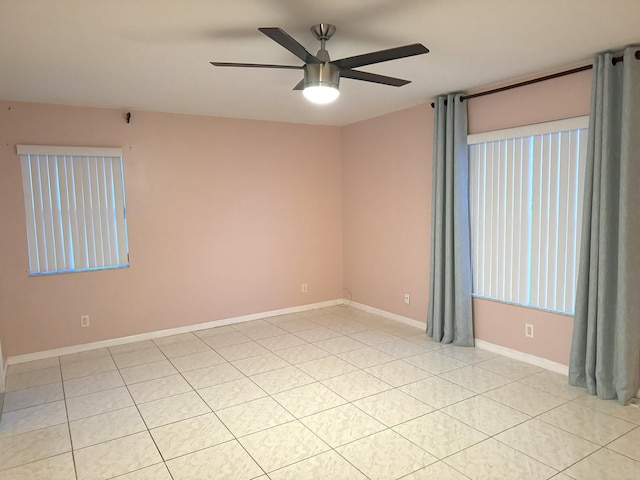 tiled spare room with ceiling fan