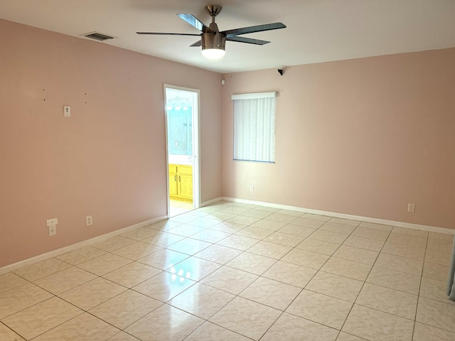 tiled spare room with ceiling fan