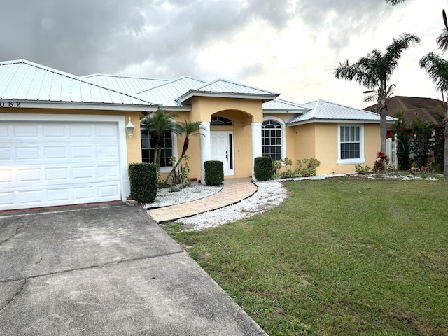 ranch-style house with a garage and a front lawn