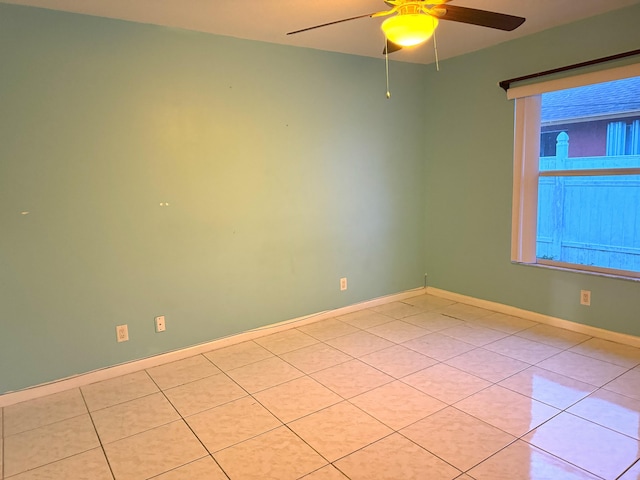 unfurnished room with ceiling fan and light tile patterned flooring