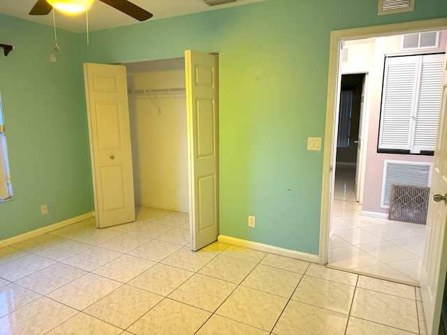 unfurnished bedroom featuring light tile patterned floors, a closet, and ceiling fan