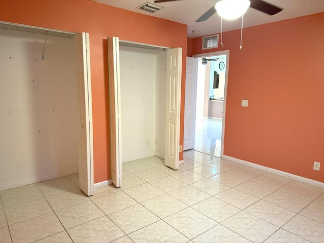 unfurnished bedroom featuring ceiling fan, a closet, and light tile patterned floors