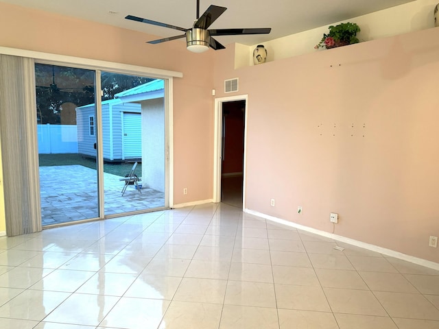 tiled spare room with ceiling fan