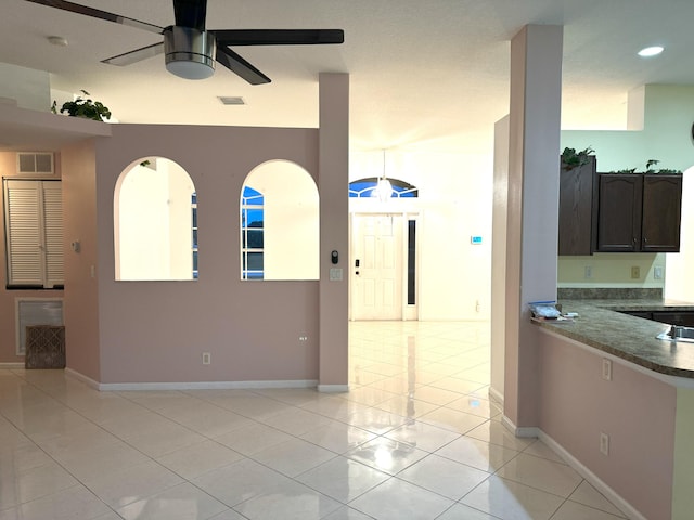 interior space featuring ceiling fan and light tile patterned floors