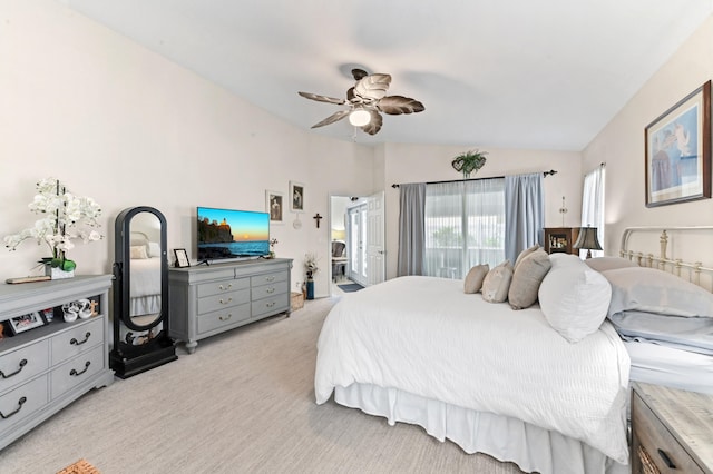 bedroom featuring light carpet, ensuite bathroom, ceiling fan, and lofted ceiling