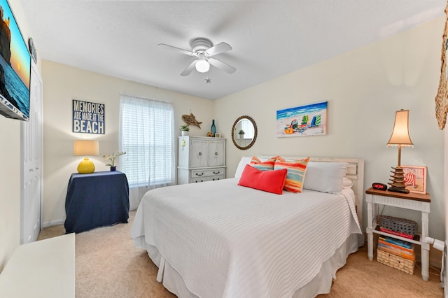 carpeted bedroom featuring ceiling fan and a closet