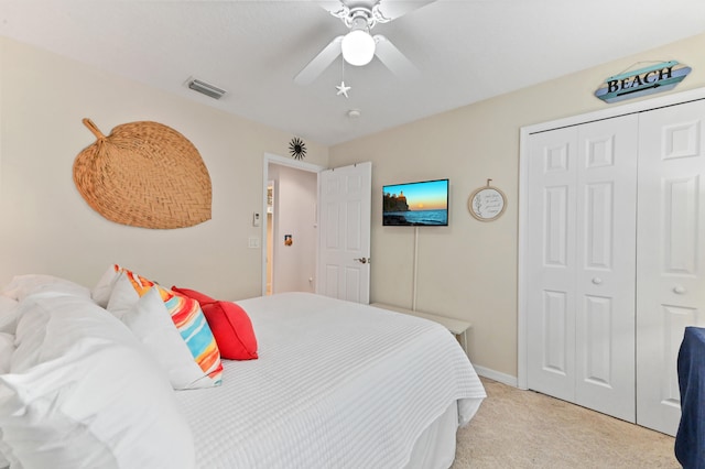 carpeted bedroom featuring ceiling fan and a closet