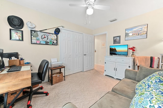 carpeted office space featuring ceiling fan