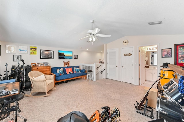 carpeted living room with ceiling fan and lofted ceiling