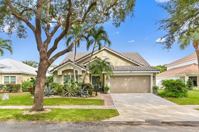 view of front of home featuring a front yard and a garage