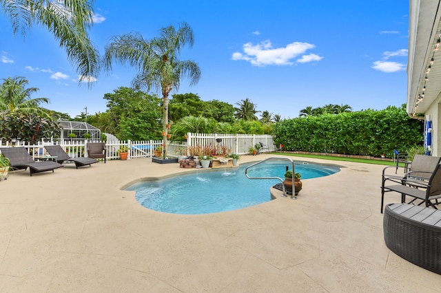 view of swimming pool featuring pool water feature and a patio area