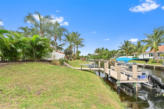 view of dock featuring a water view and a lawn