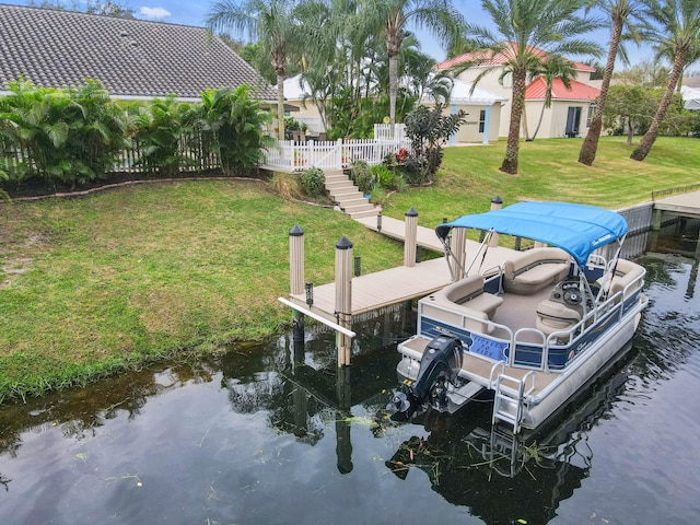 dock area with a yard and a water view