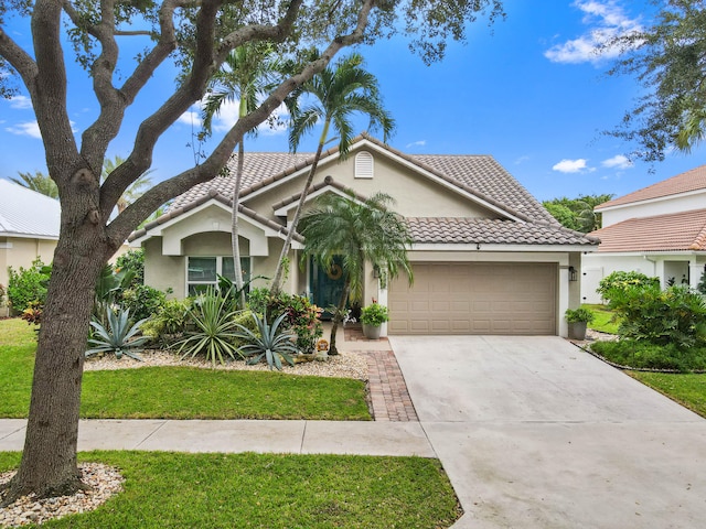 view of front of house featuring a garage and a front lawn