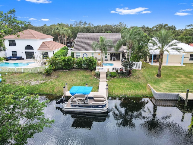 rear view of property featuring a yard and a water view