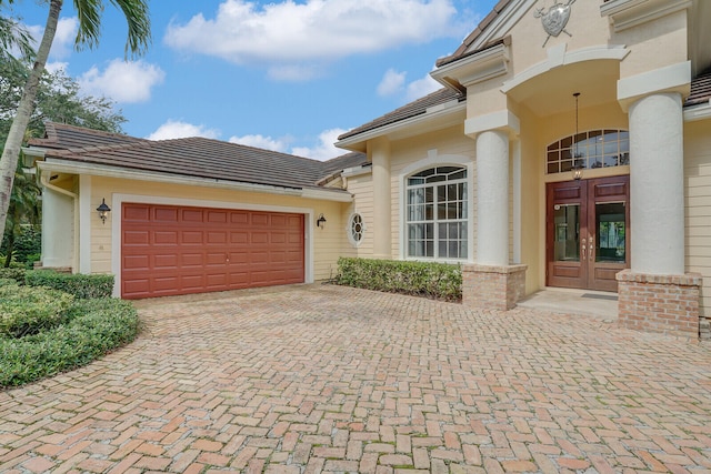 view of front of property featuring french doors and a garage