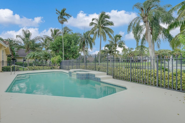 view of swimming pool featuring an in ground hot tub