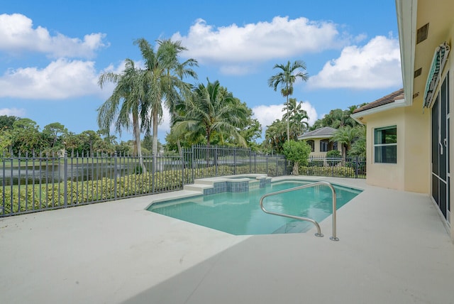 view of swimming pool with an in ground hot tub and a patio